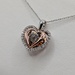  10KT TWO TONE GOLD ~.13 TOTAL CARAT WT. DANCING DIAMOND TRIPLE HEART PENDANT
