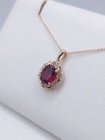  14KT ROSE GOLD ~1.25 CARAT OVAL GARNET WITH DIAMOND ACCENTS 5/8" PENDANT