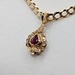  18KT YELLOW GOLD ~.37 TOTAL GEM WT. RUBY AND DIAMOND HALO STYLE 1/2" PENDANT
